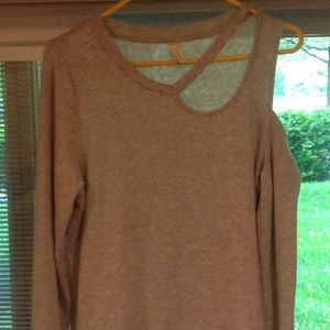Tunic style top with one cold shoulder.
